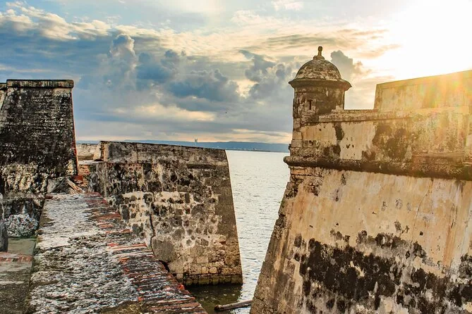 The weathered stone walls and sentry box of a colonial fort by the sea